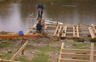 Placing piles for a deck over water.