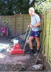 Man with big machine makes big noise to build patio